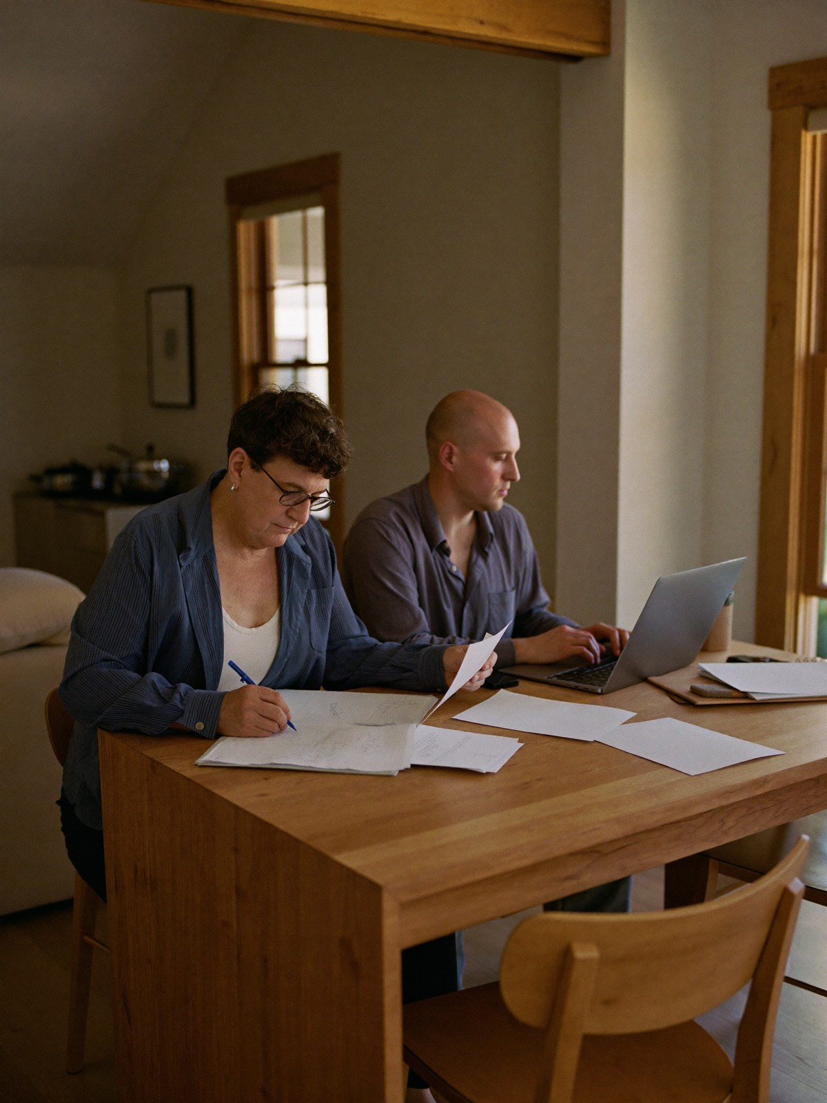 Couple organizing closing records at a kitchen table