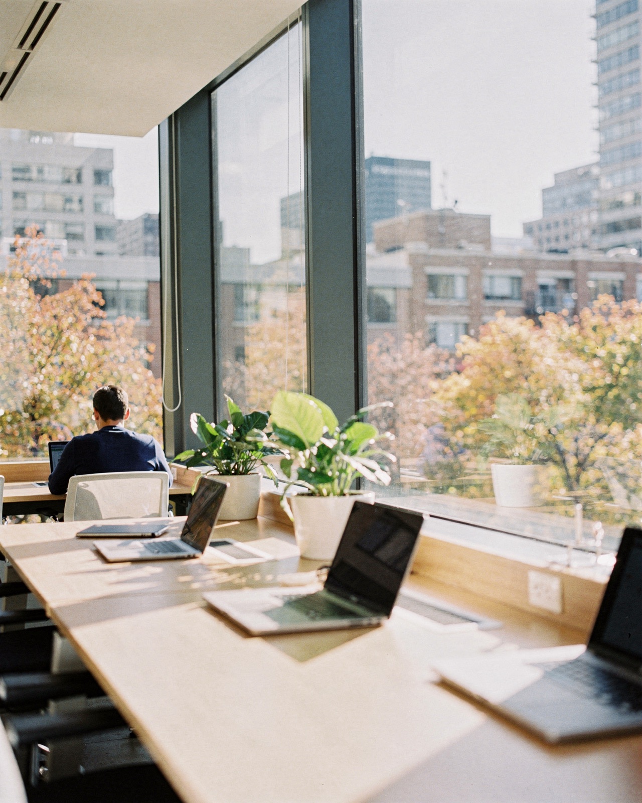 Illustrative photo of a bright, modern office with large windows. Not a picture of our office.